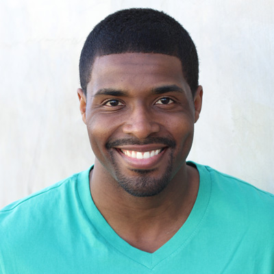 An elderly couple poses together with smiles, sharing a moment of happiness.