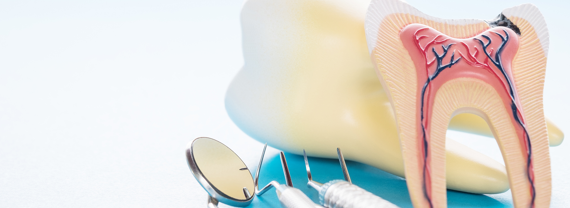 The image shows a pair of yellow sunglasses with a blue toothbrush resting on top of them.