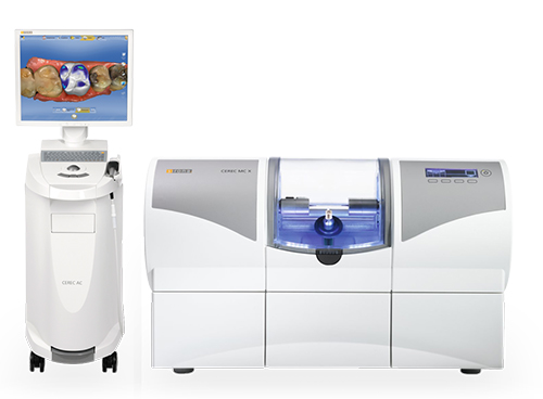 The image shows two machines, likely used for dental procedures, with a monitor displaying an image of teeth and a machine with a blue light on top, set against a white background with a floor lamp visible at the bottom right corner.